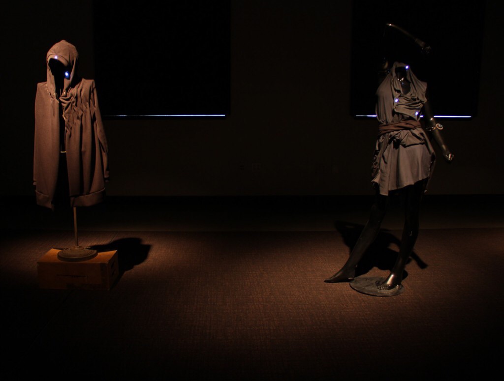 Dark cloaks with small blue lights and electronics woven in.